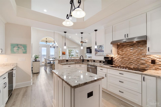 5136 Point Shores Ln, Gulf Breeze, FL 32563 - kitchen with stainless steel dishwasher, a peninsula, black electric cooktop, under cabinet range hood, and backsplash