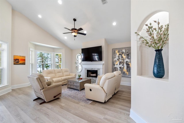 5136 Point Shores Ln, Gulf Breeze, FL 32563 - living room featuring baseboards, a ceiling fan, light wood finished floors, and a fireplace