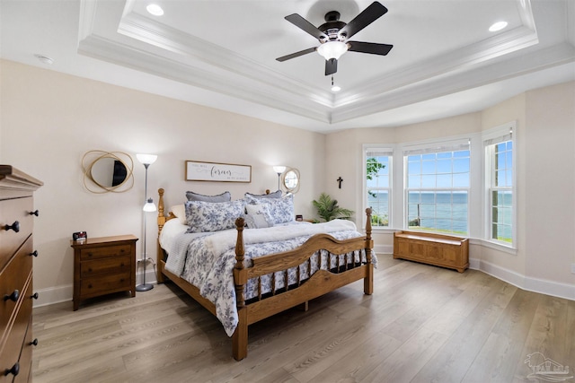 5136 Point Shores Ln, Gulf Breeze, FL 32563 - bedroom with recessed lighting, a tray ceiling, ornamental molding, and light wood-type flooring