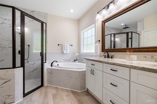 5136 Point Shores Ln, Gulf Breeze, FL 32563 - bathroom featuring wood finished floors, a marble finish shower, a bath, and vanity
