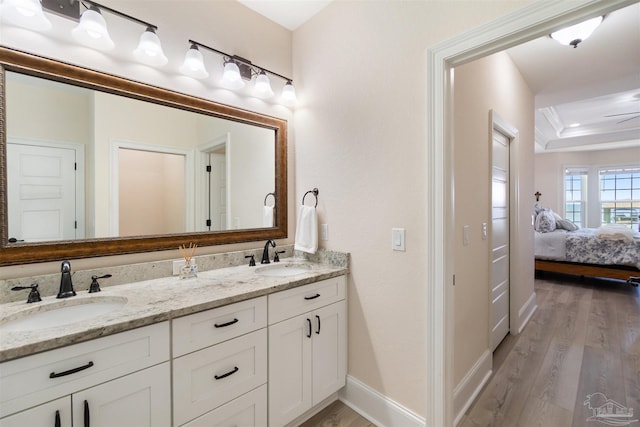 5136 Point Shores Ln, Gulf Breeze, FL 32563 - ensuite bathroom with baseboards, a sink, ensuite bathroom, and wood finished floors