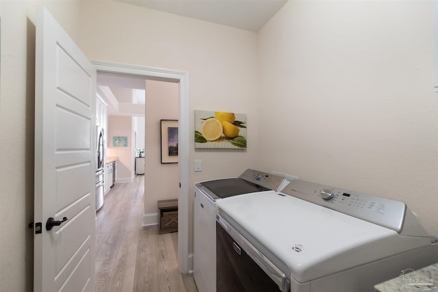 5136 Point Shores Ln, Gulf Breeze, FL 32563 - clothes washing area featuring baseboards, separate washer and dryer, laundry area, and light wood-style flooring