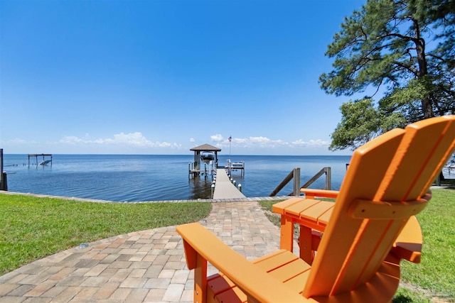 5136 Point Shores Ln, Gulf Breeze, FL 32563 - exterior space with boat lift, a patio, a boat dock, a lawn, and a water view