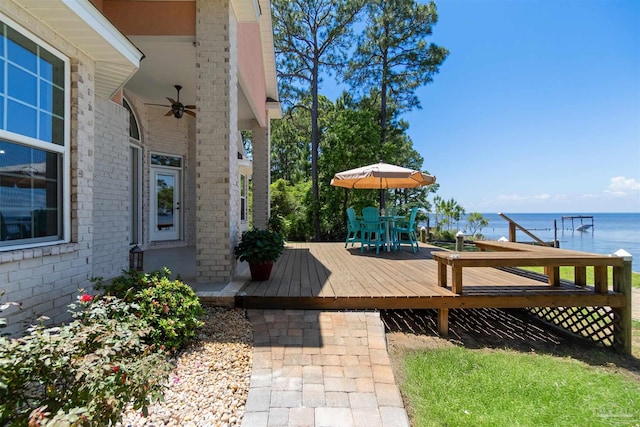 5136 Point Shores Ln, Gulf Breeze, FL 32563 - wooden terrace featuring a water view, ceiling fan, and outdoor dining space