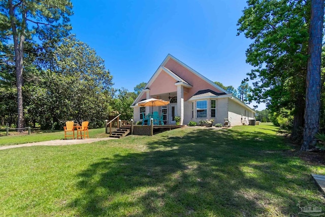 5136 Point Shores Ln, Gulf Breeze, FL 32563 - rear view of house featuring a yard, a deck, ceiling fan, and fence