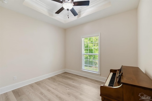 5136 Point Shores Ln, Gulf Breeze, FL 32563 - unfurnished room with baseboards, ornamental molding, a tray ceiling, and light wood-type flooring