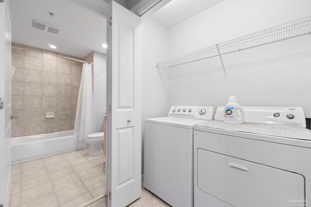 laundry area with light tile patterned floors, recessed lighting, laundry area, visible vents, and washer and clothes dryer