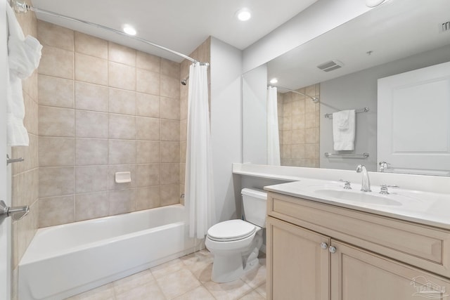 full bathroom with visible vents, toilet, tile patterned flooring, shower / bath combo with shower curtain, and vanity