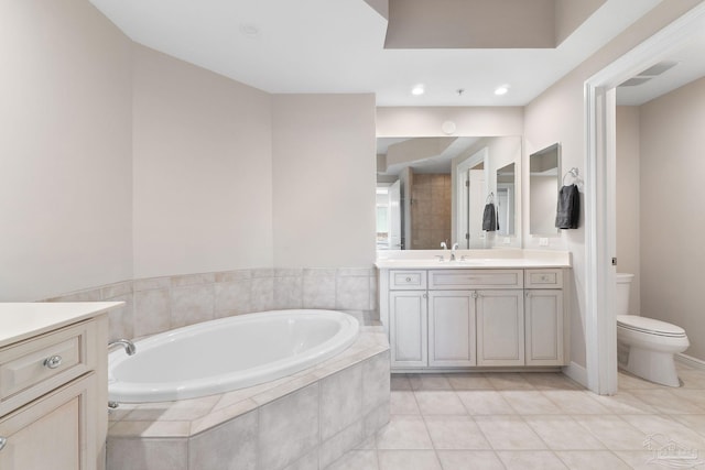 bathroom with toilet, tile patterned floors, a garden tub, vanity, and recessed lighting