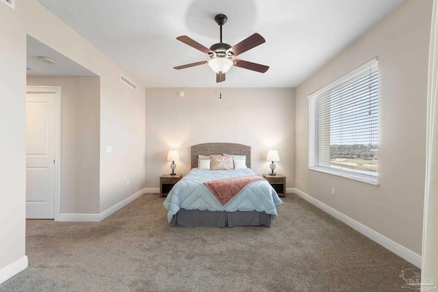 bedroom with ceiling fan, carpet flooring, visible vents, and baseboards