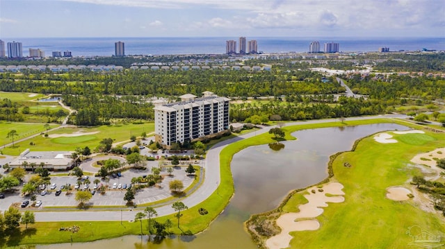 birds eye view of property featuring golf course view, a water view, and a city view