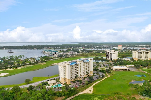 drone / aerial view featuring view of golf course, a water view, and a city view