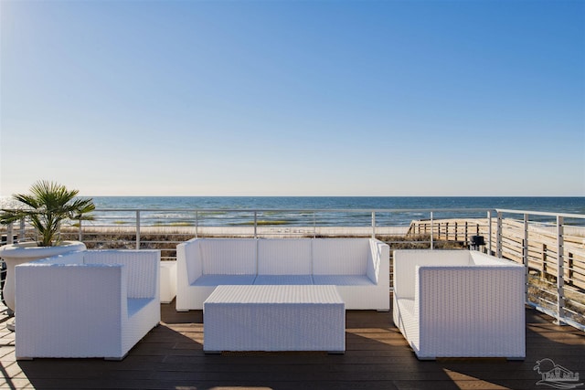 wooden terrace with an outdoor hangout area, a beach view, and a water view