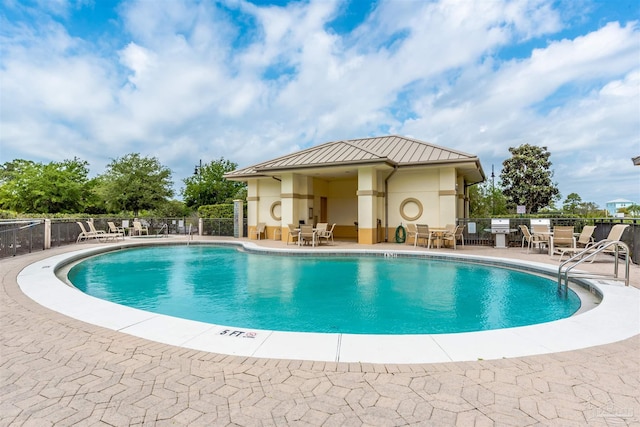 pool featuring a patio and fence