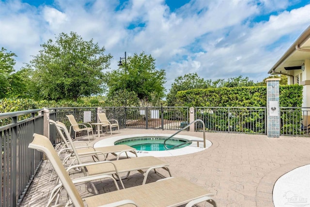 view of pool with a community hot tub and a patio area