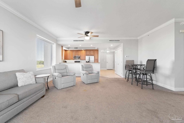 living room with ornamental molding, light colored carpet, visible vents, and baseboards