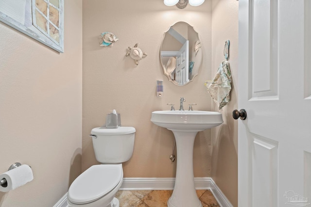 bathroom featuring tile patterned flooring and toilet