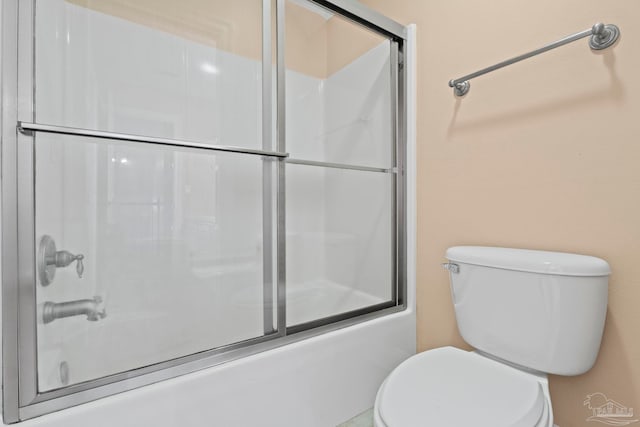 bathroom with enclosed tub / shower combo and toilet