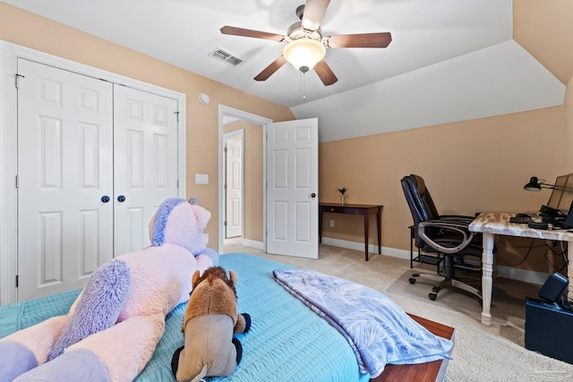 bedroom with ceiling fan, lofted ceiling, light carpet, and a closet