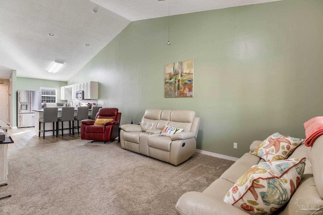 living room with lofted ceiling and light colored carpet