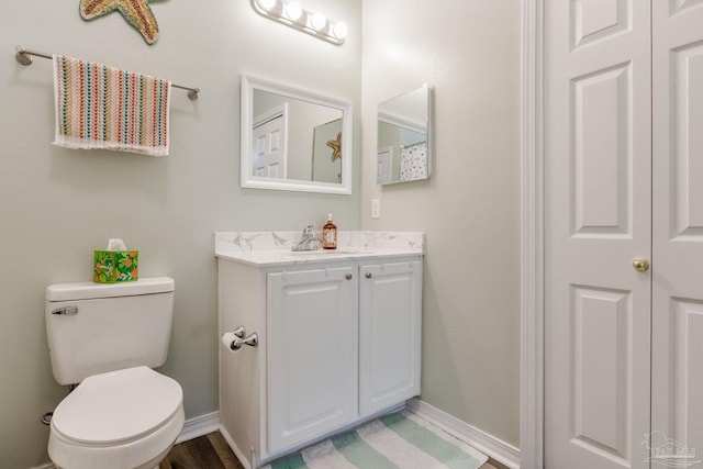 bathroom featuring toilet and vanity