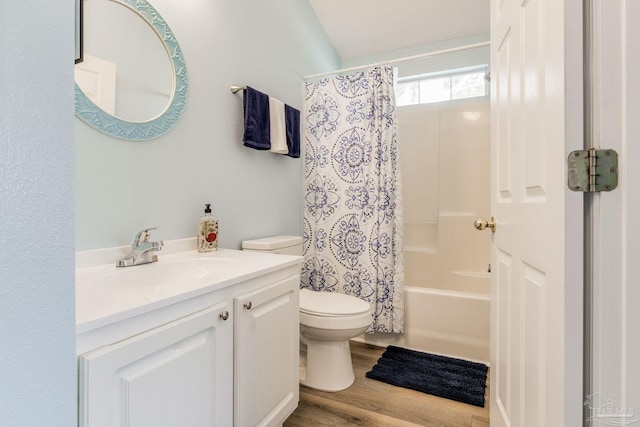 full bathroom featuring toilet, hardwood / wood-style flooring, vanity, and shower / bath combo with shower curtain