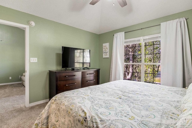 carpeted bedroom with ceiling fan and lofted ceiling