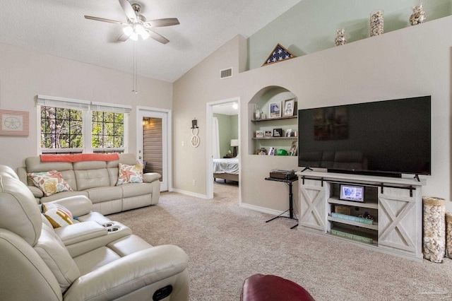 carpeted living room featuring ceiling fan, a textured ceiling, built in features, and high vaulted ceiling