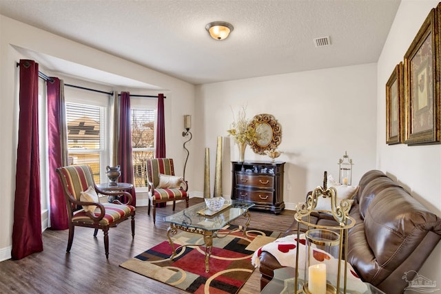 living room featuring a textured ceiling and dark hardwood / wood-style floors