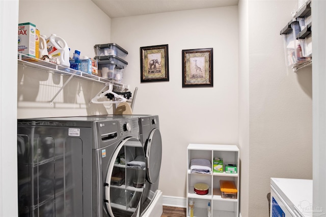 laundry room featuring washer and dryer and wood-type flooring