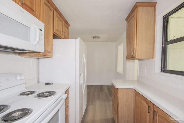 60 Stanford Rd, Pensacola, FL 32506 - kitchen featuring white appliances, dark wood-type flooring, light countertops, backsplash, and brown cabinetry