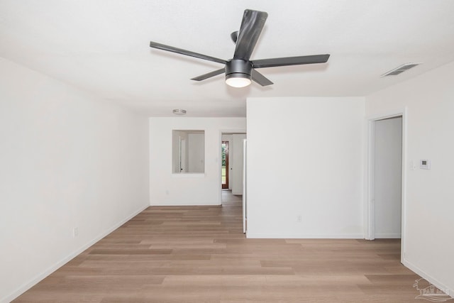 spare room featuring light hardwood / wood-style flooring and ceiling fan