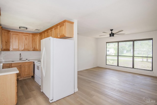 60 Stanford Rd, Pensacola, FL 32506 - kitchen with white appliances, light wood finished floors, a sink, light countertops, and backsplash