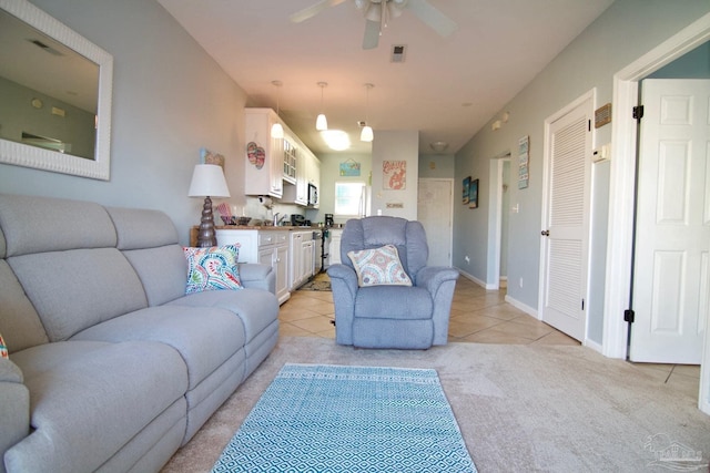 carpeted living room featuring ceiling fan