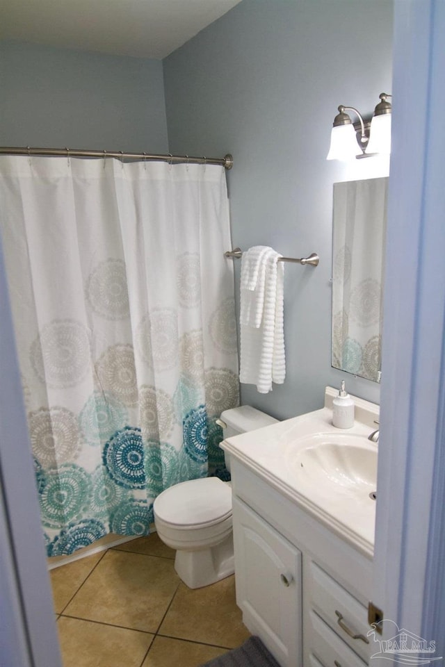 bathroom with tile patterned flooring, vanity, toilet, and a shower with curtain