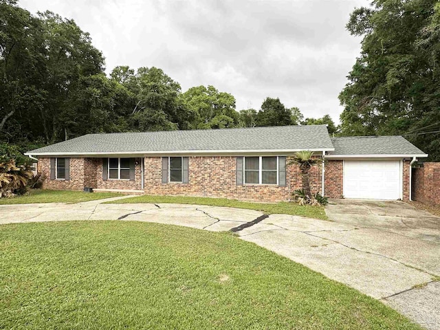 6910 Cornelius Ln, Pensacola, FL 32505 - single story home with driveway, an attached garage, a front lawn, and brick siding
