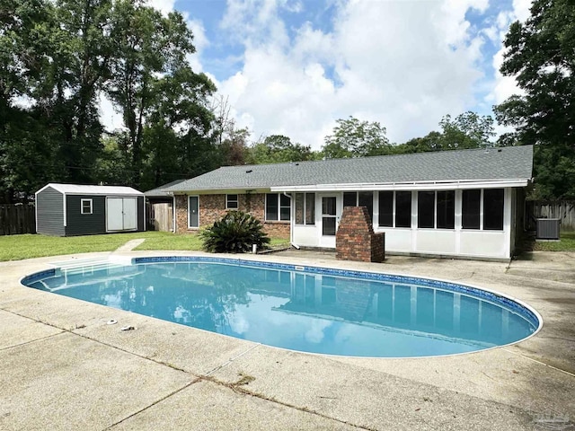 6910 Cornelius Ln, Pensacola, FL 32505 - outdoor pool with a shed, a sunroom, and a lawn