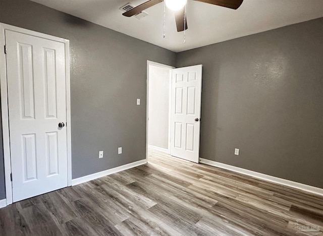 6910 Cornelius Ln, Pensacola, FL 32505 - unfurnished bedroom featuring wood finished floors and ceiling fan