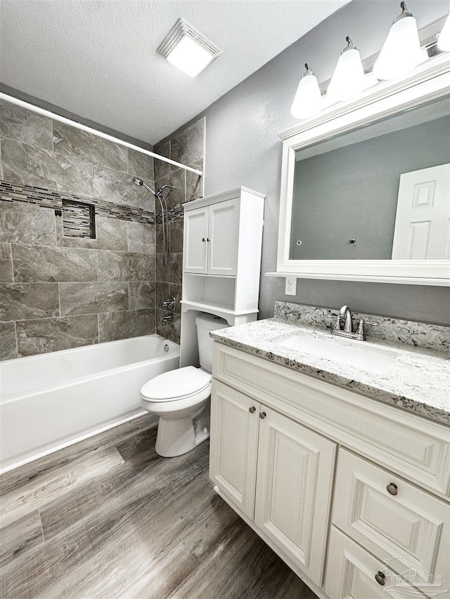 6910 Cornelius Ln, Pensacola, FL 32505 - bathroom with wood finished floors,  shower combination, vanity, and a textured ceiling