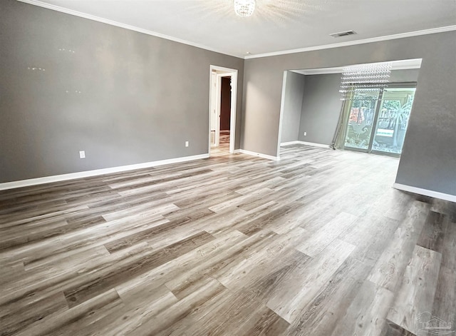 6910 Cornelius Ln, Pensacola, FL 32505 - unfurnished room featuring a chandelier, wood finished floors, and crown molding
