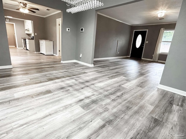 6910 Cornelius Ln, Pensacola, FL 32505 - unfurnished living room featuring crown molding, light wood-style flooring, and a ceiling fan