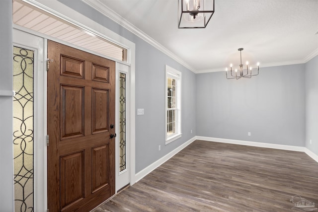 entryway featuring ornamental molding, dark wood-type flooring, and a notable chandelier