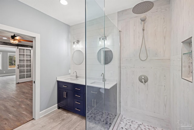 bathroom with an enclosed shower, hardwood / wood-style floors, vanity, and ceiling fan