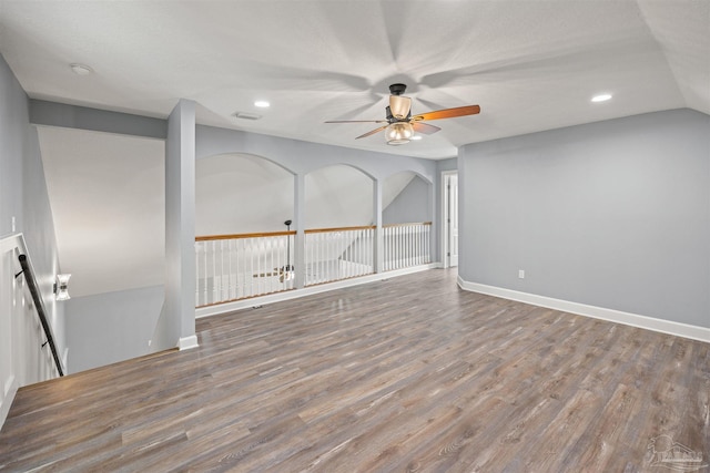 unfurnished living room with hardwood / wood-style flooring, ceiling fan, and vaulted ceiling