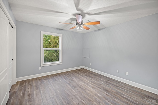 empty room featuring hardwood / wood-style floors, a textured ceiling, and ceiling fan