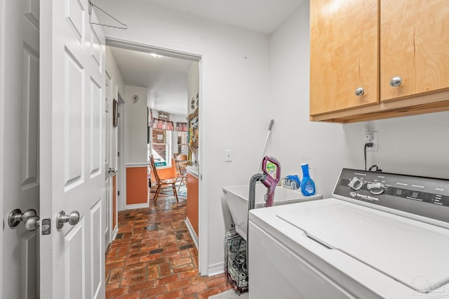 6552 Emerald Forest Dr, Milton, FL 32570 - laundry area with washer / dryer, cabinet space, and brick flooring