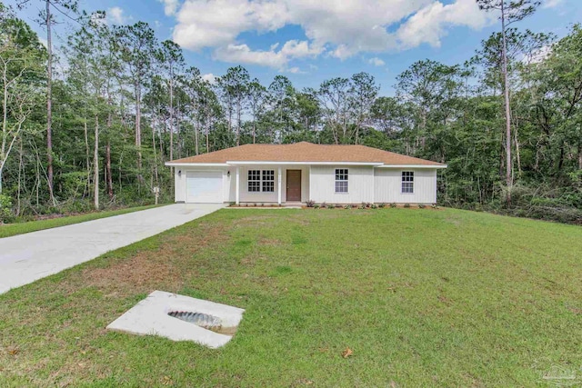 view of front of house with a garage and a front lawn