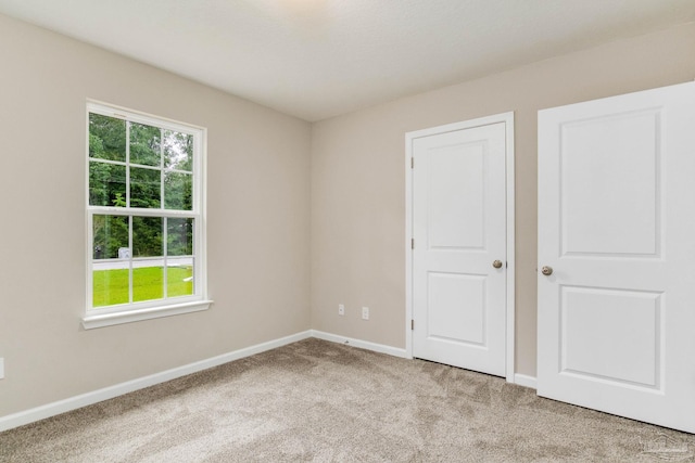 unfurnished bedroom with light colored carpet