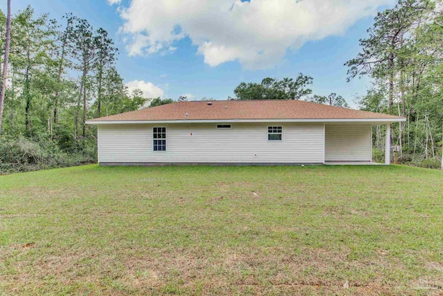 rear view of house featuring a yard