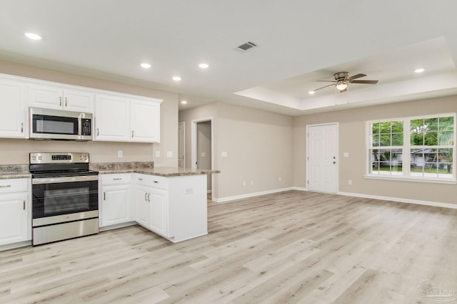 kitchen featuring light hardwood / wood-style floors, white cabinetry, and appliances with stainless steel finishes